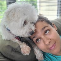 Charlotte's animal care playing with cute small white dog at a dog sitting and dog walking appointment in Greenville, sc